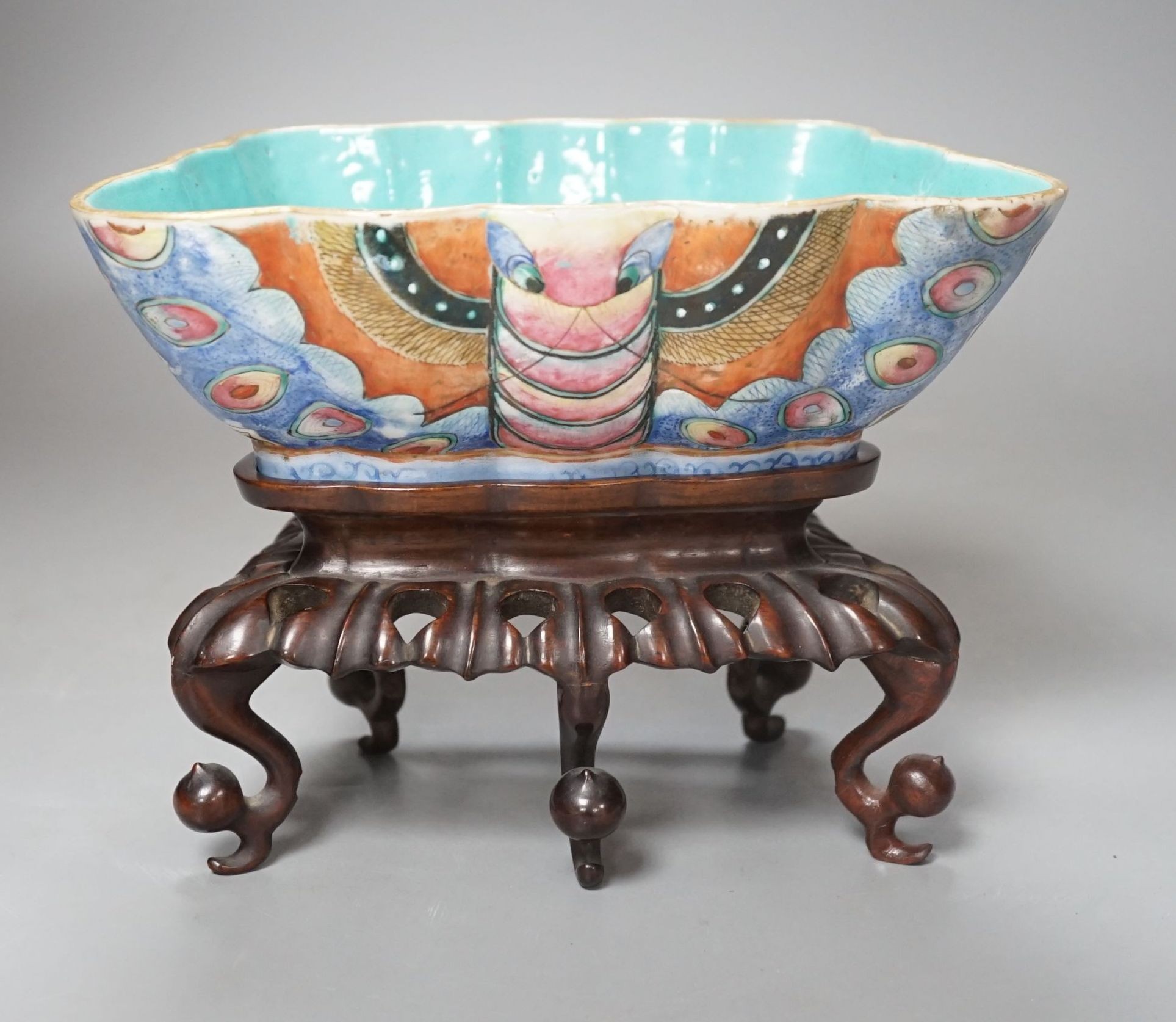 A 19th century Chinese enamelled porcelain ‘butterfly’ bowl, hongmu stand, 21 cms wide x 8 cms high.